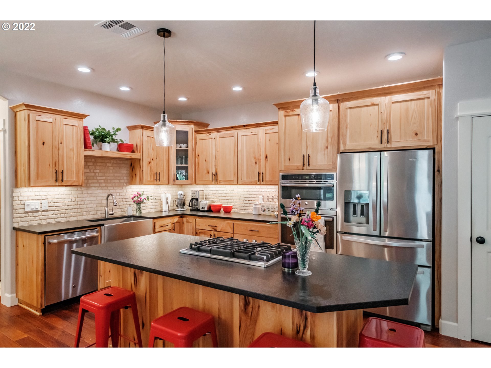 339 Mountaingate Drive Springfield, OR 97478 - Photo 7 of 32 a kitchen with stainless steel appliances granite countertop a sink refrigerator and microwave