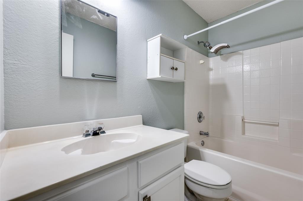 8405 Seven Oaks Lane Denton, TX 76210 - Photo 10 of 11 a bathroom with a sink toilet vanity and shower