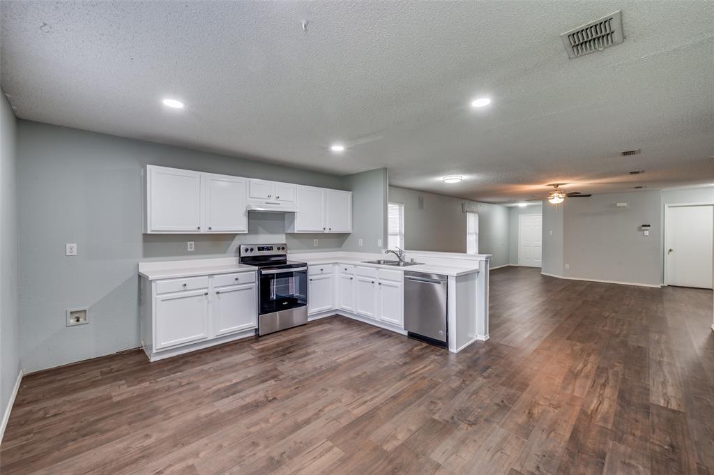 8405 Seven Oaks Lane Denton, TX 76210 - Photo 11 of 11 a kitchen with a white cabinets and stove top oven