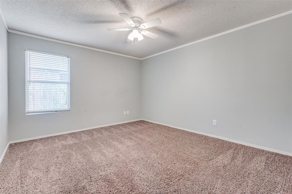 8405 Seven Oaks Lane Denton, TX 76210 - Photo 9 of 11 an empty room with windows and fan