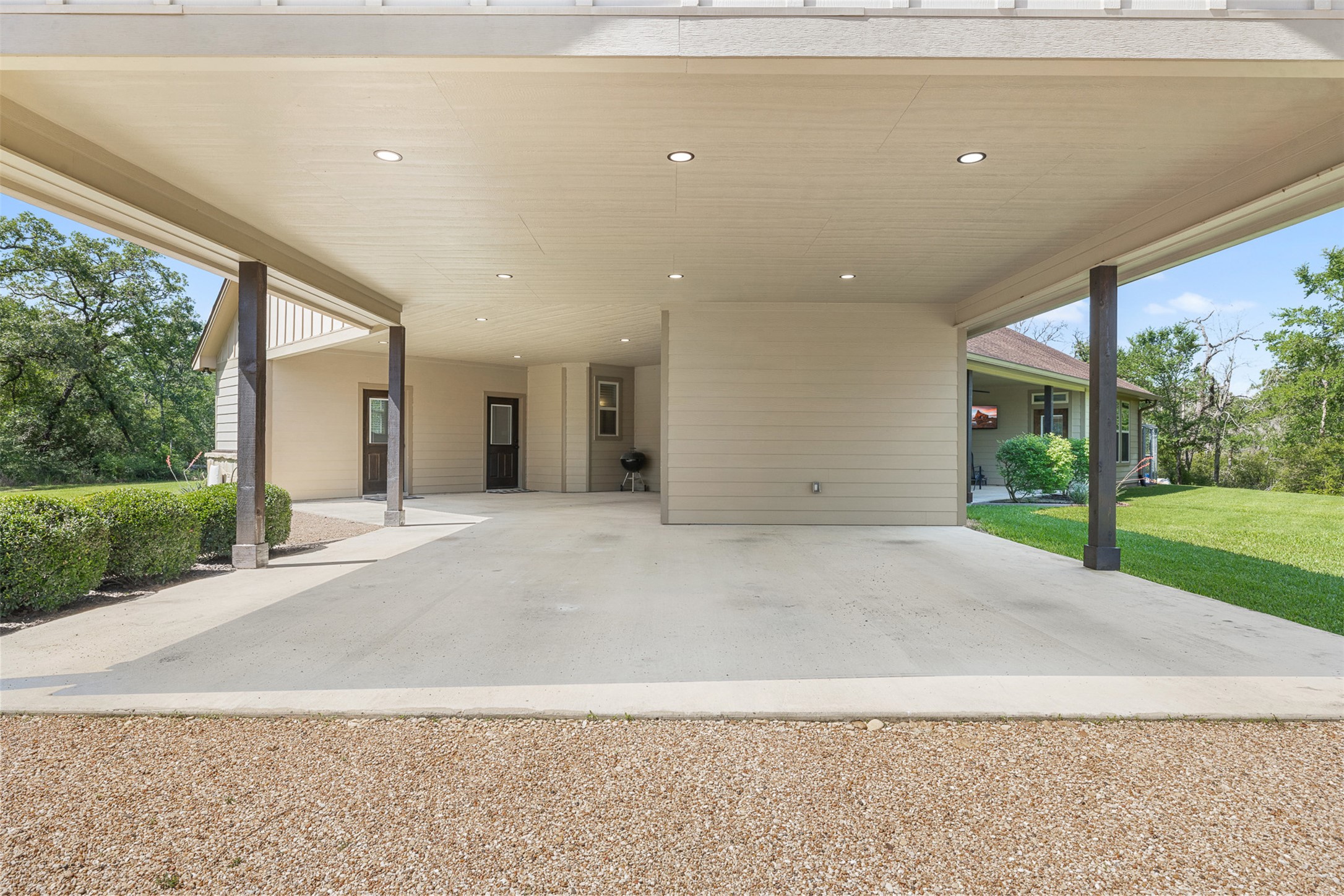 1306 22 Hills Road Gause, TX 77857 - Photo 21 of 40 Expansive covered concrete carport with recessed lighting, supported by multiple columns