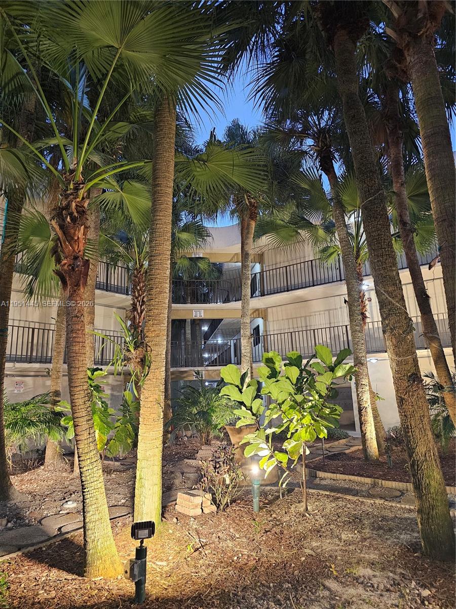 8075 Southwest 107th Avenue, Unit 114 Miami, FL 33173 - Photo 13 of 18 a view of a garden with chair and potted plants