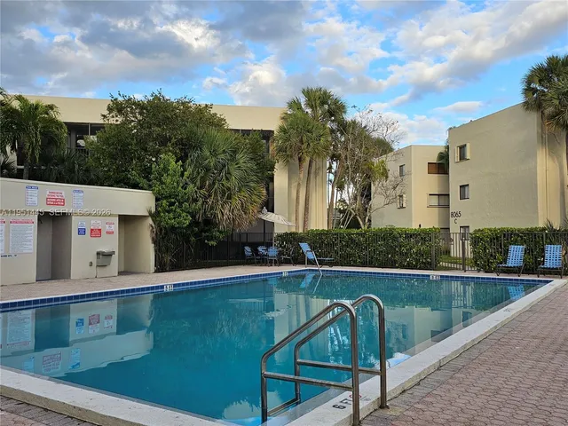 swimming pool view with a outdoor seating space