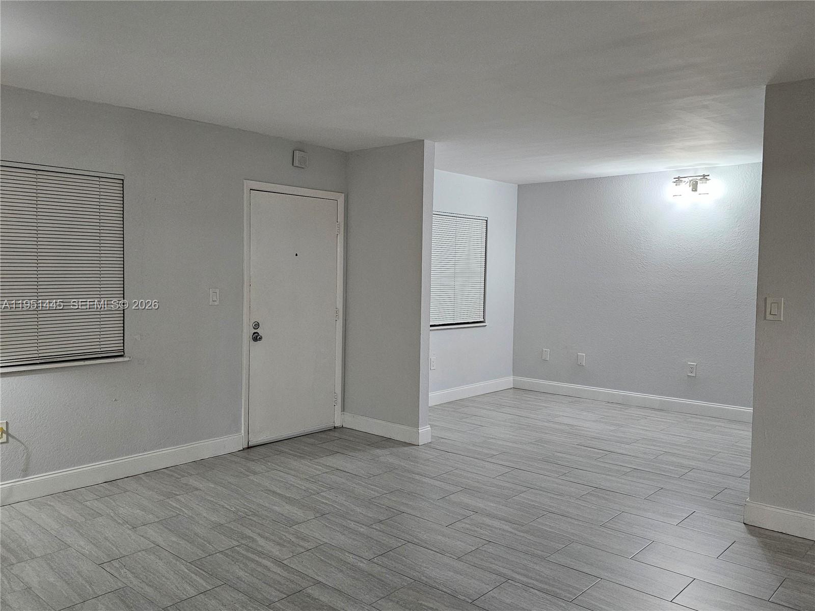 8075 Southwest 107th Avenue, Unit 114 Miami, FL 33173 - Photo 3 of 18 a view of an empty room with wooden floor