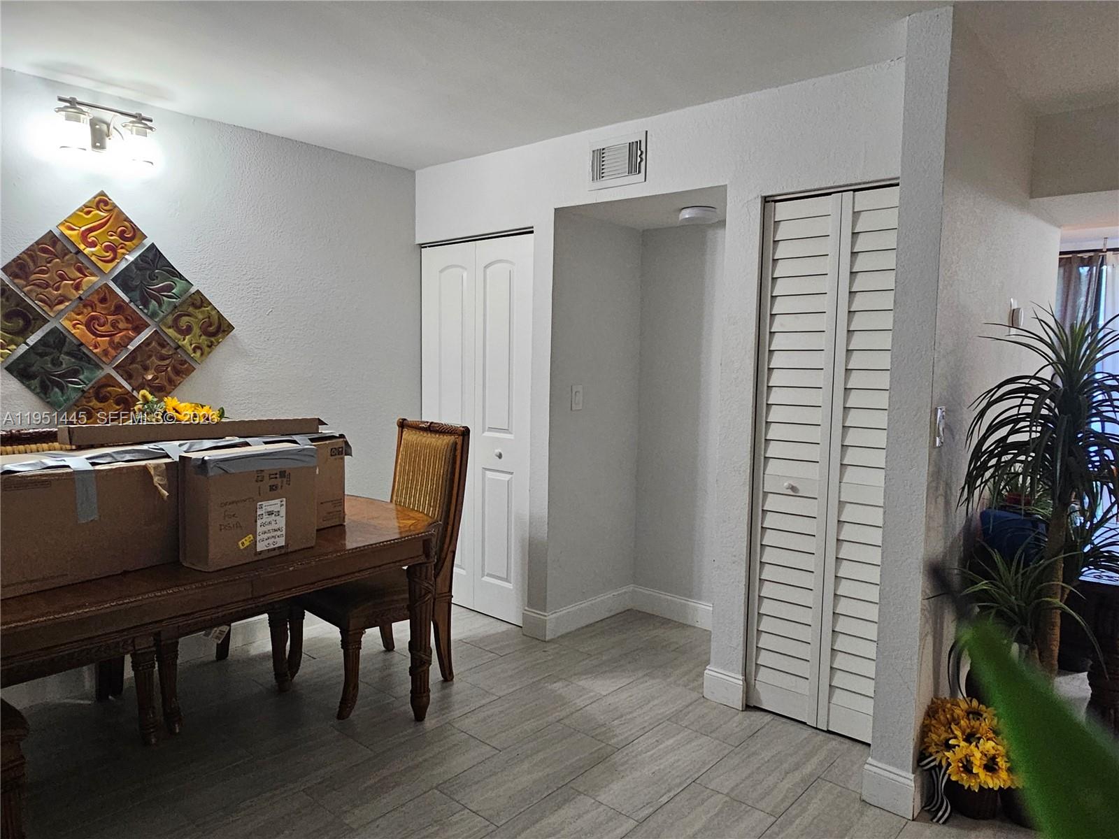 8075 Southwest 107th Avenue, Unit 114 Miami, FL 33173 - Photo 5 of 18 a view of a dining room with furniture and wooden floor