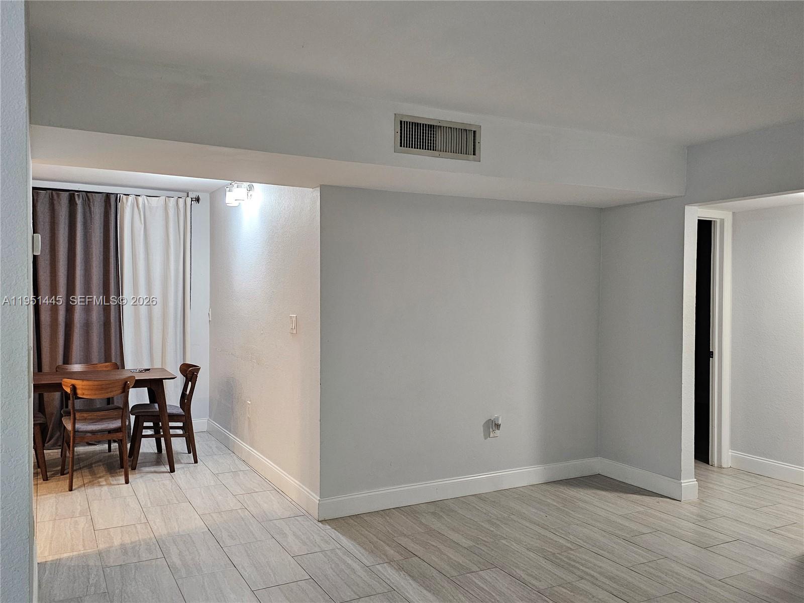 8075 Southwest 107th Avenue, Unit 114 Miami, FL 33173 - Photo 9 of 18 a view of room with furniture and wooden floor