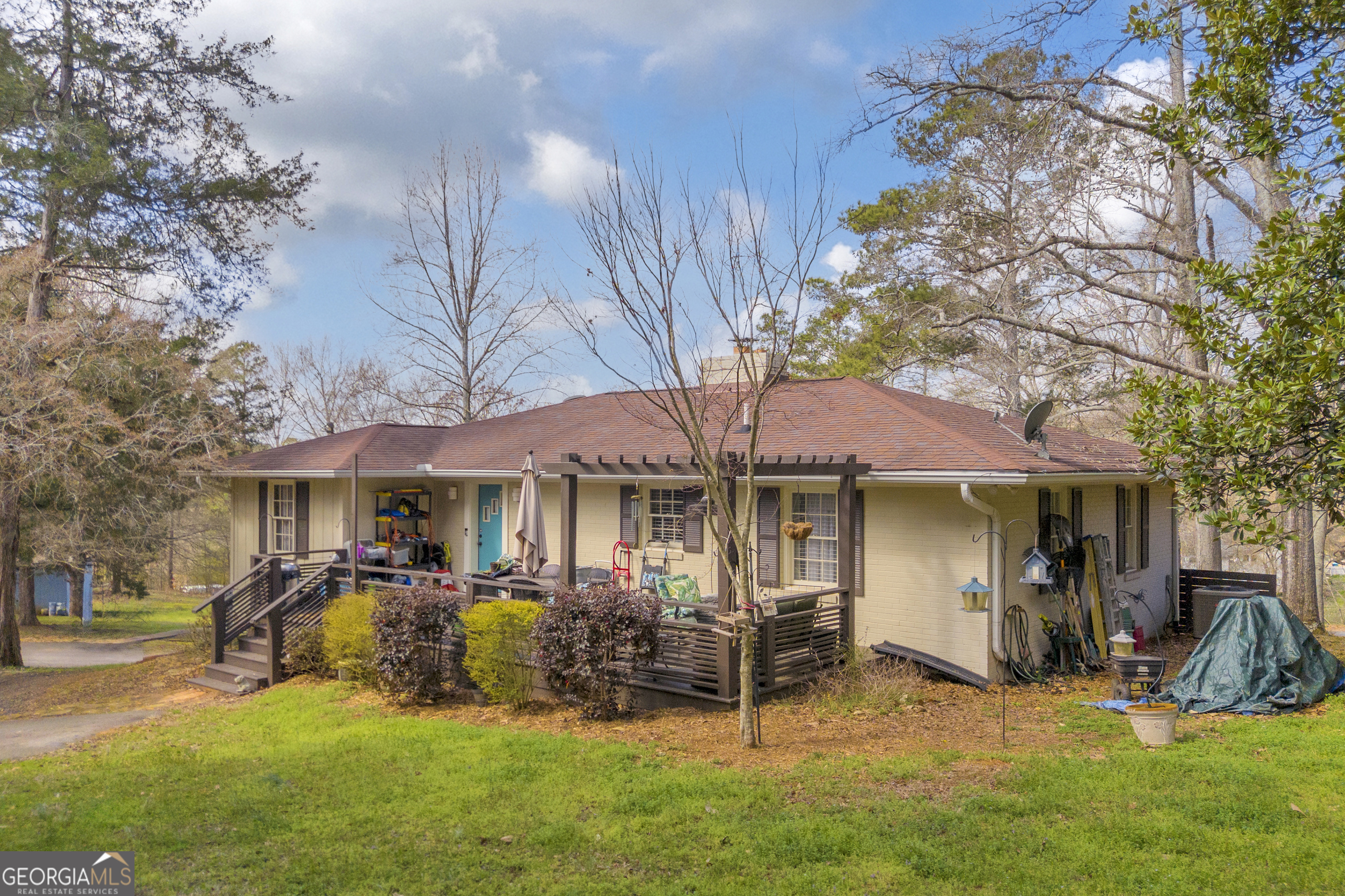 136 Frazier Hill Road Bishop, GA 30621 - Photo 2 of 59 a view of a patio with table and chairs under an umbrella