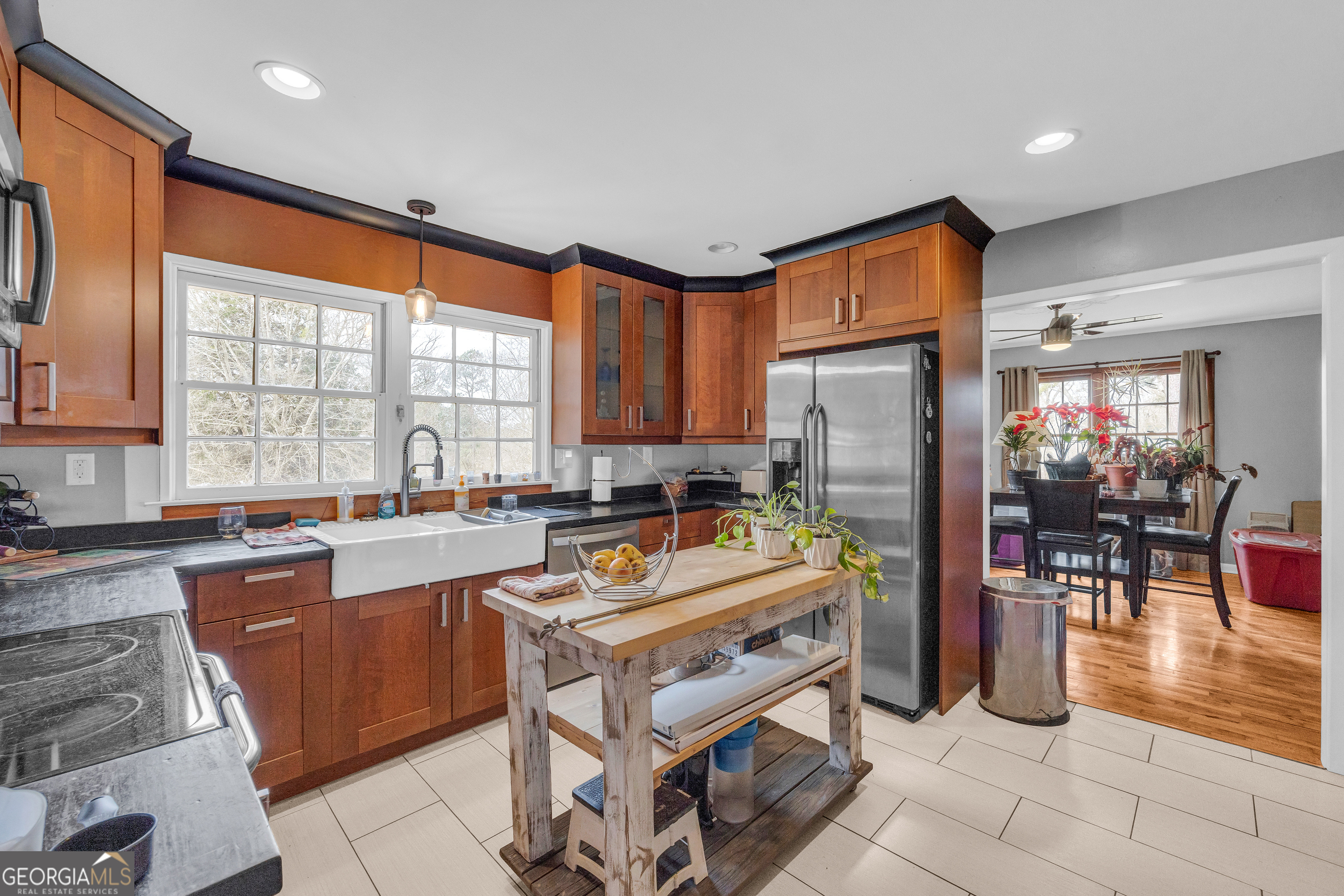 136 Frazier Hill Road Bishop, GA 30621 - Photo 21 of 59 a kitchen with stainless steel appliances granite countertop a refrigerator a sink a stove and chairs