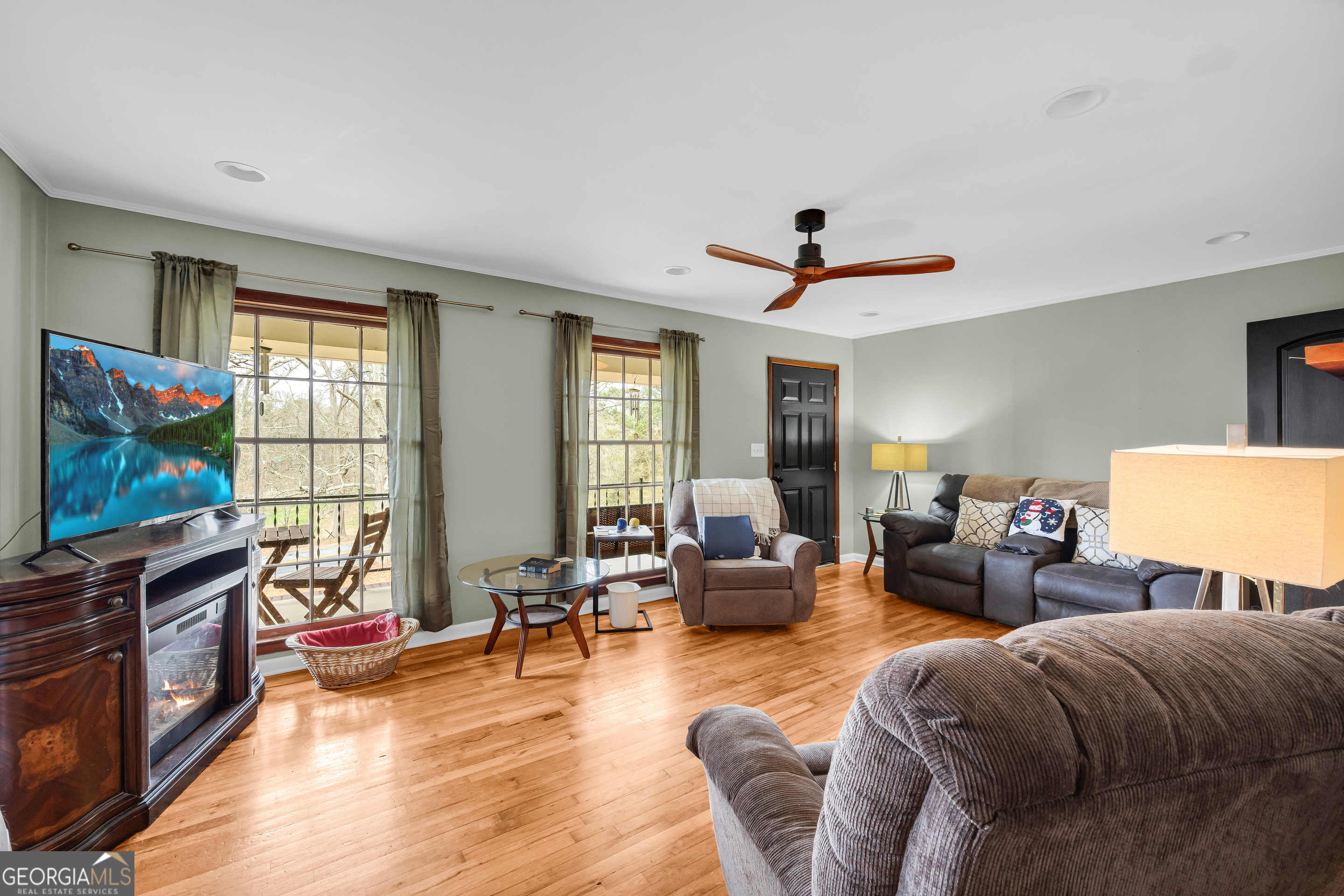 136 Frazier Hill Road Bishop, GA 30621 - Photo 26 of 59 a living room with furniture a flat screen tv and wooden floor
