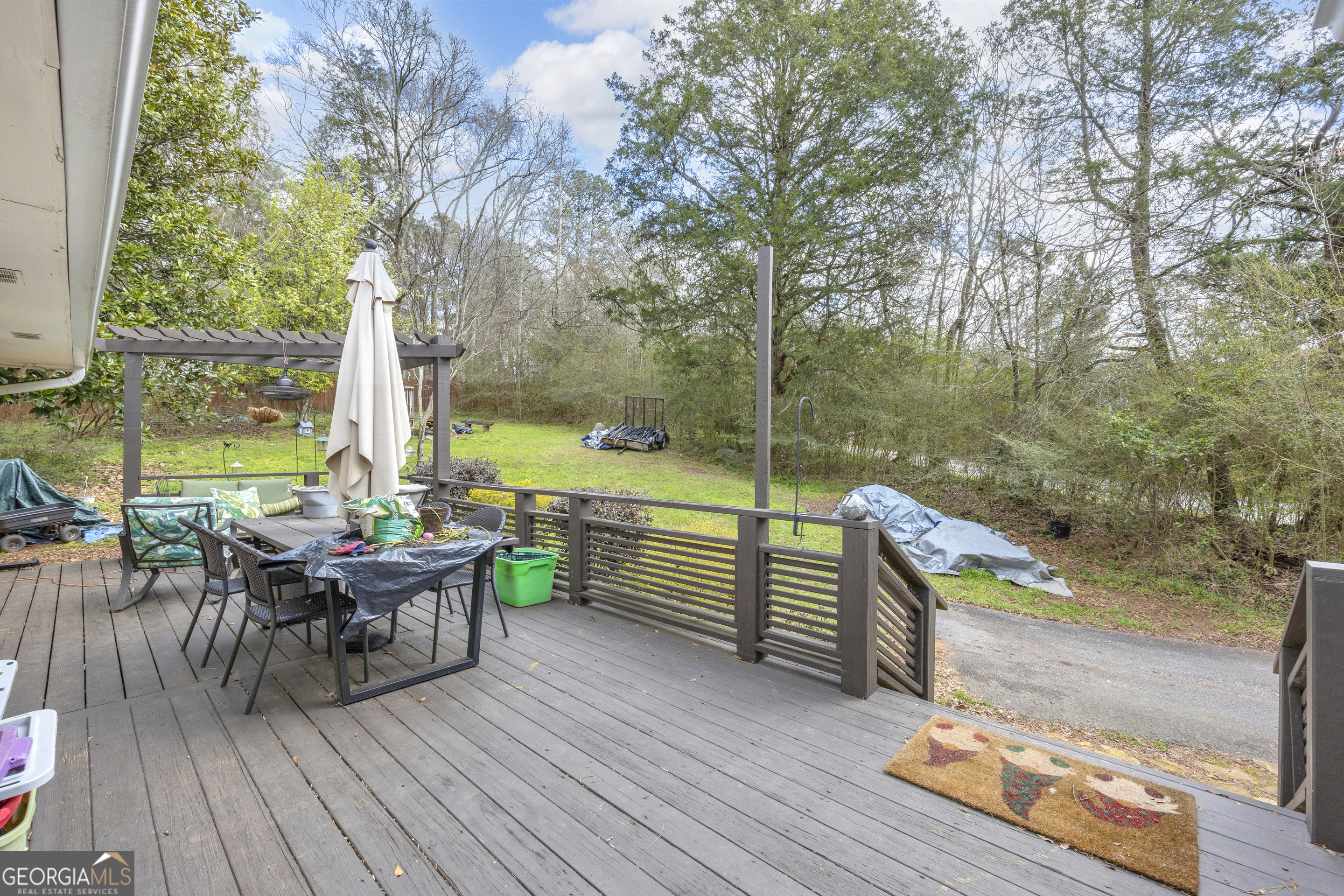 136 Frazier Hill Road Bishop, GA 30621 - Photo 40 of 59 a view of a deck with table and chairs and wooden floor