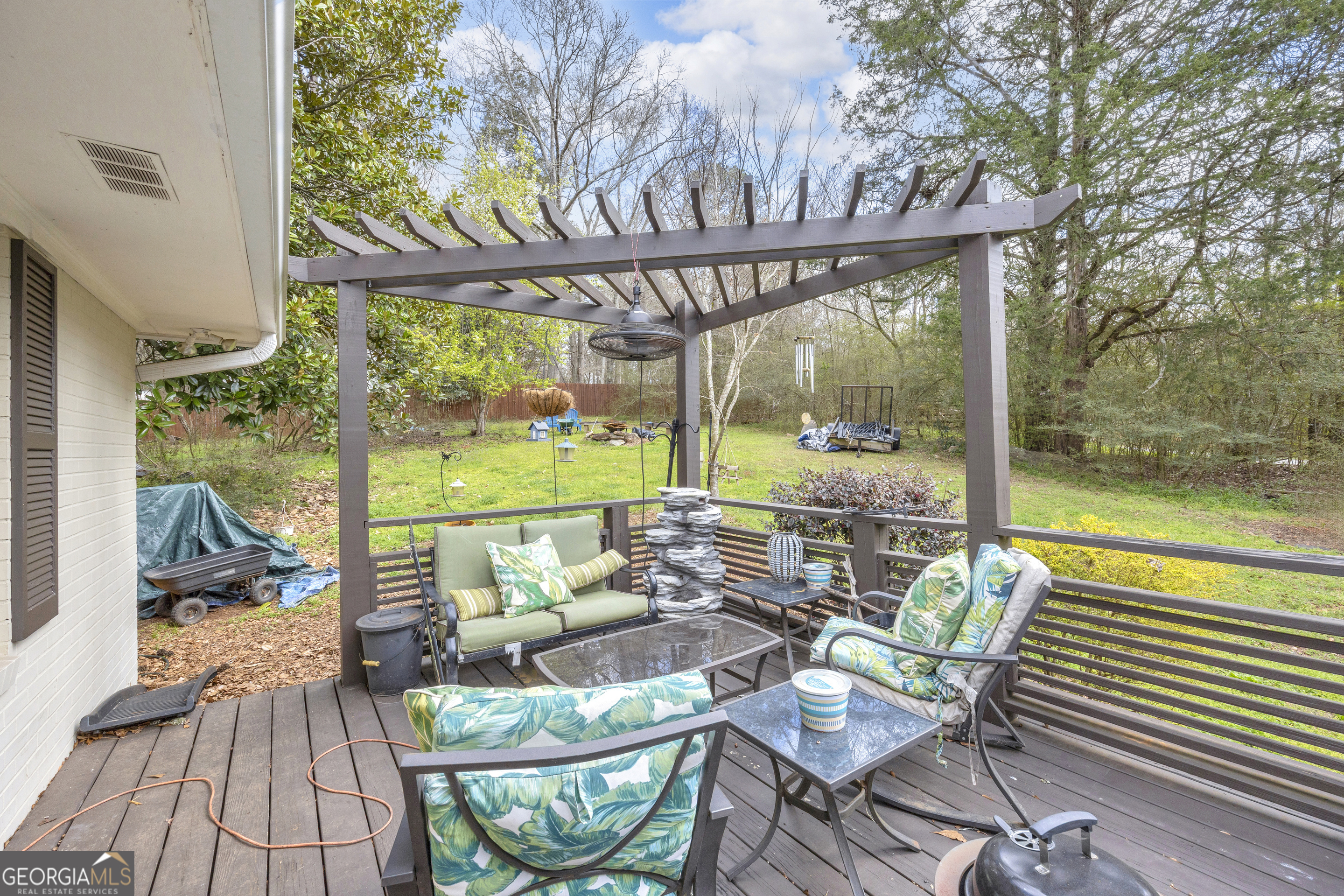 136 Frazier Hill Road Bishop, GA 30621 - Photo 41 of 59 a patio with wooden floor table and chairs