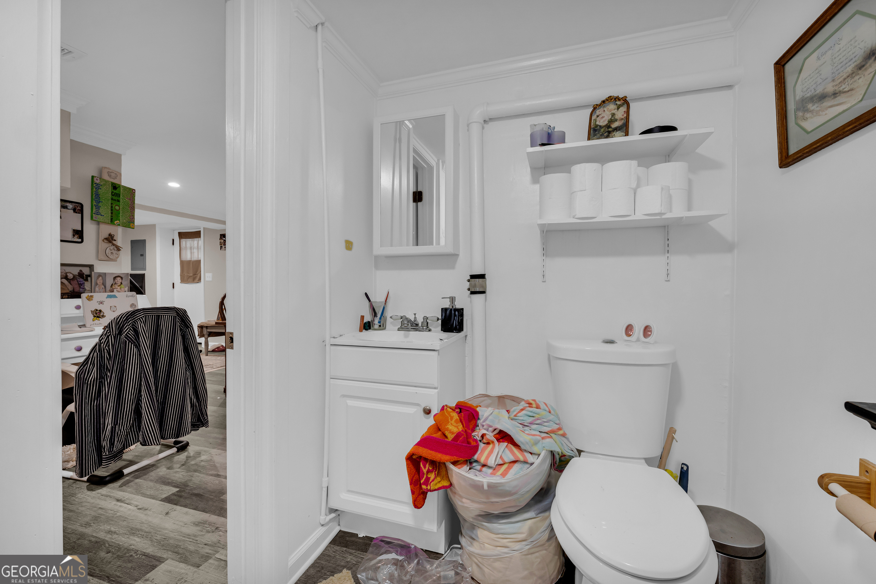 136 Frazier Hill Road Bishop, GA 30621 - Photo 54 of 59 a white toilet sitting next to a bathroom sink and vanity