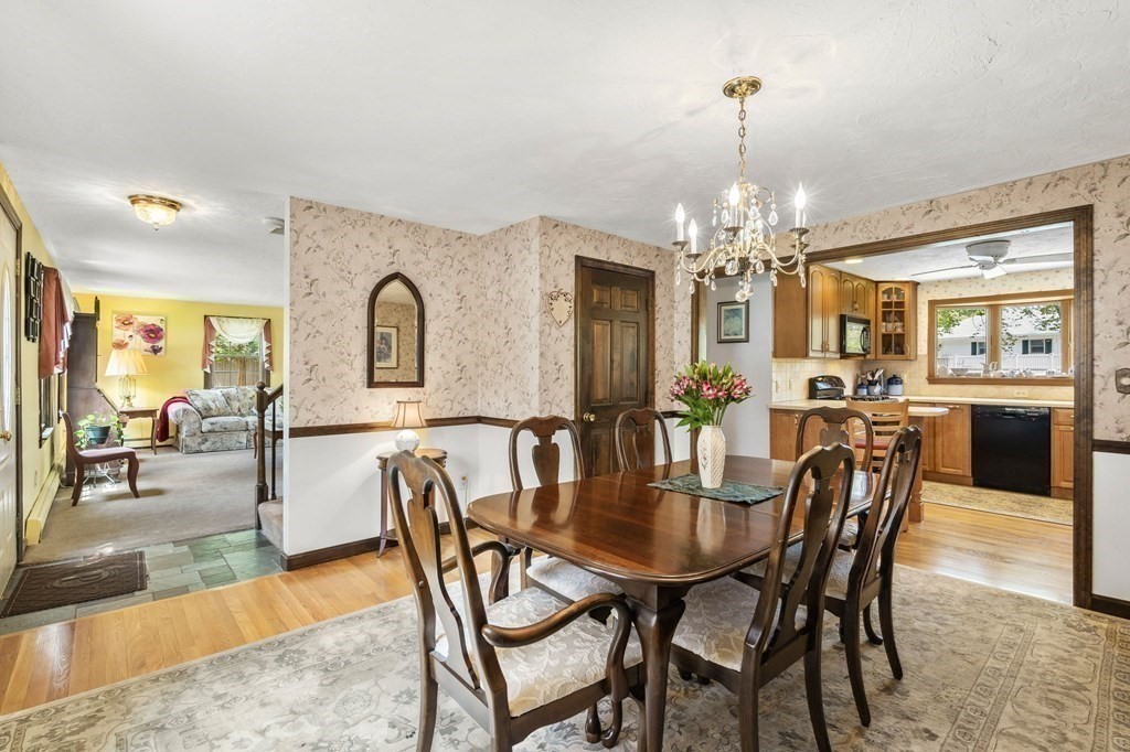 23 Indian Path Dedham, MA 02026 - Photo 12 of 35 a dining room with furniture a chandelier and wooden floor