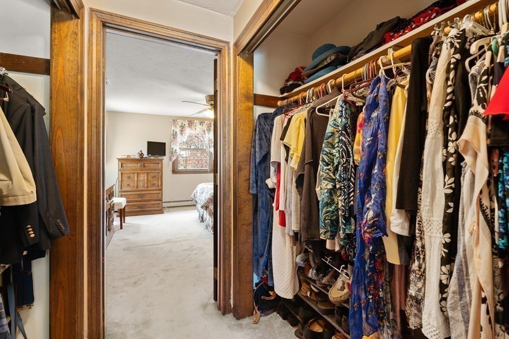 23 Indian Path Dedham, MA 02026 - Photo 18 of 35 a view of walk in closet with clothes