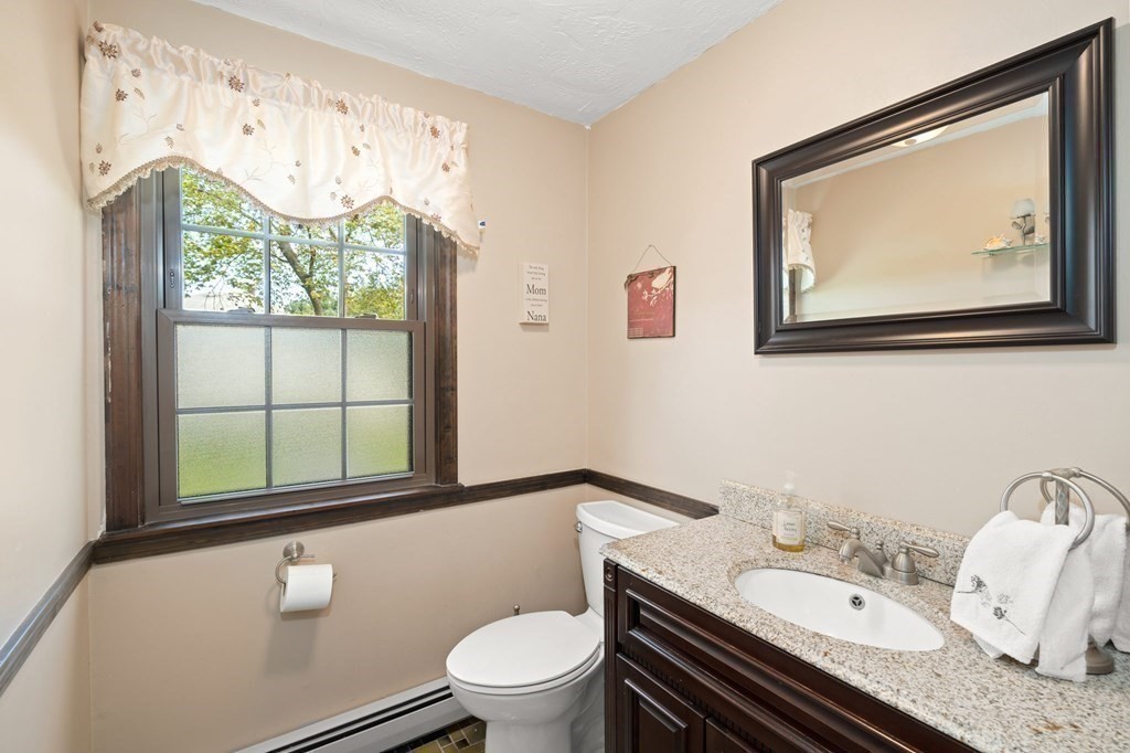23 Indian Path Dedham, MA 02026 - Photo 24 of 35 a bathroom with a granite countertop sink mirror and toilet