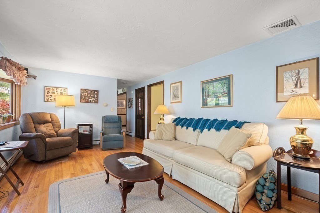 23 Indian Path Dedham, MA 02026 - Photo 9 of 35 a living room with furniture and a table