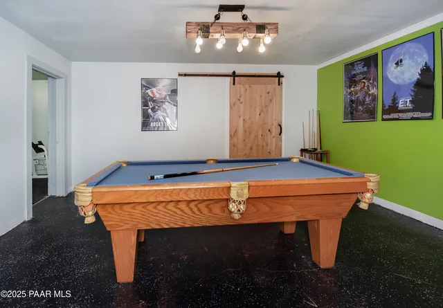a room with pool table and window