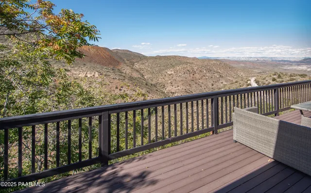 a balcony with wooden floor and mountain view