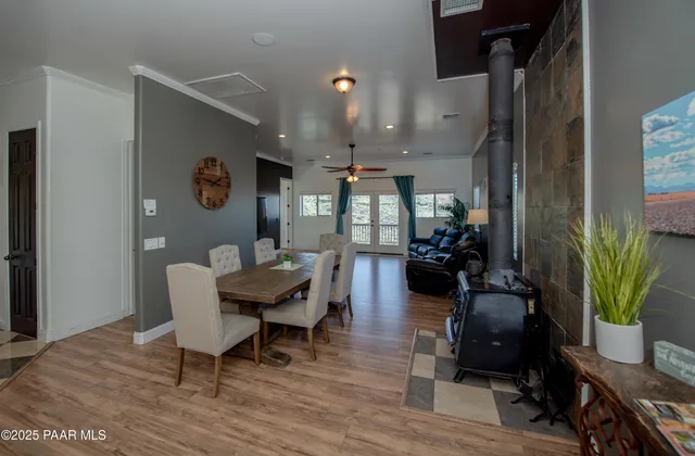 a dining room with furniture and wooden floor
