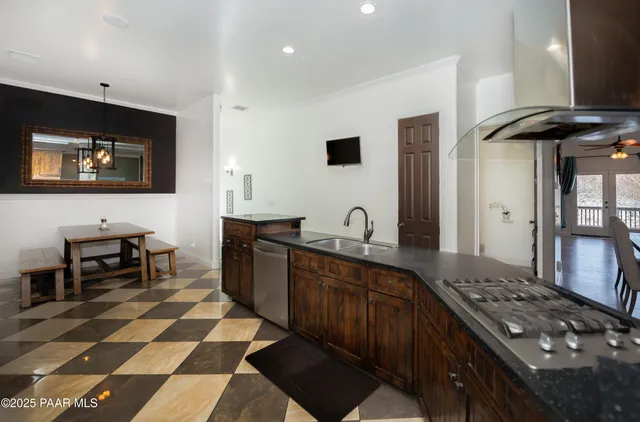 a kitchen with stainless steel appliances a stove a sink and a microwave