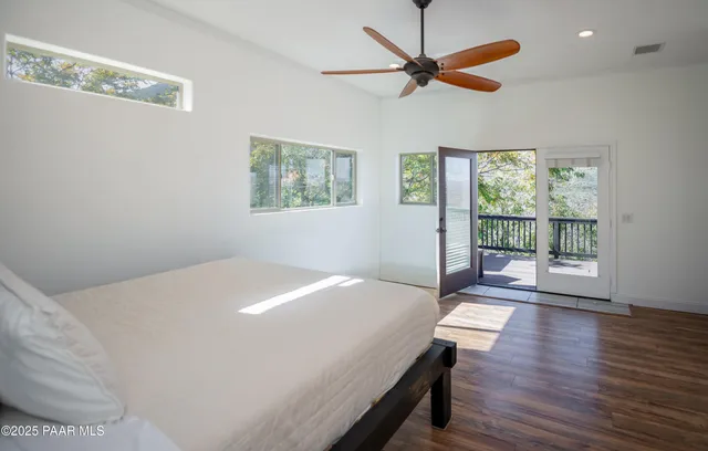 a bedroom with a bed and a large window