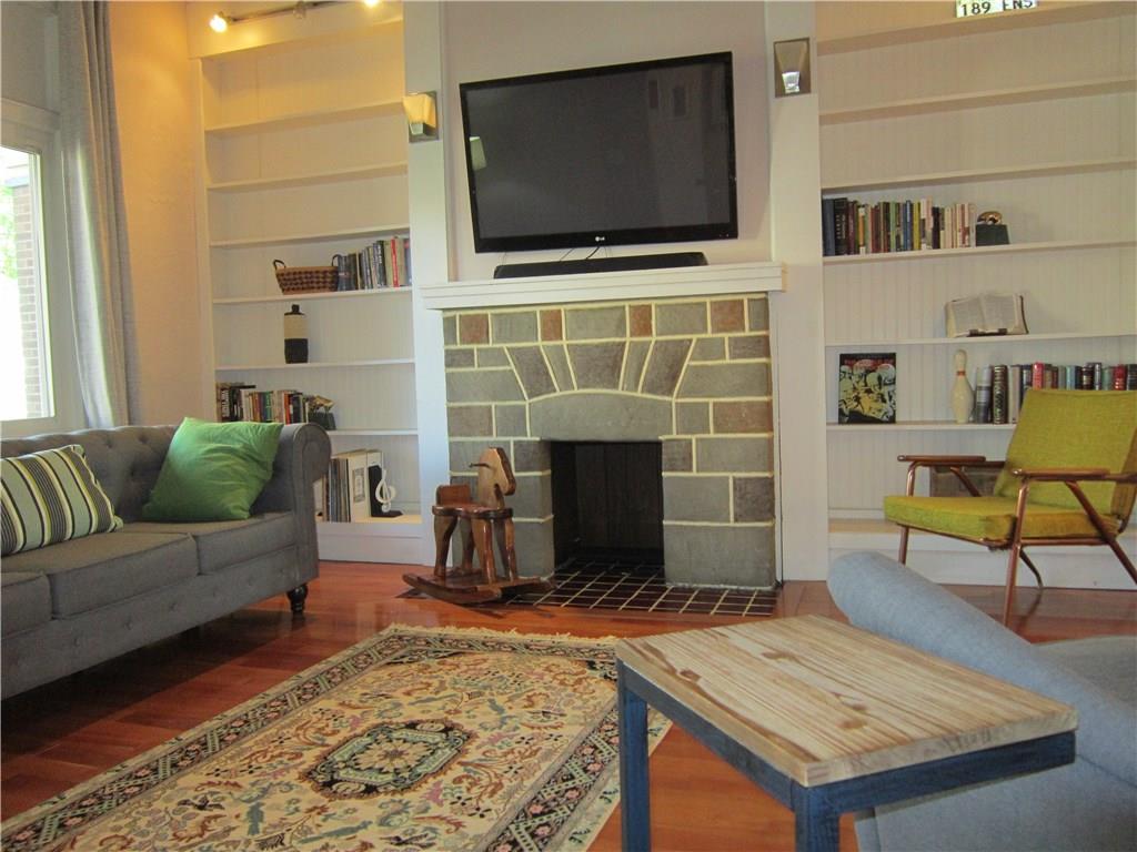 214 South Mathilda Street Friendship Park, PA 15224 - Photo 5 of 25 Living room with decorative fireplace and beautiful built-in shelves.