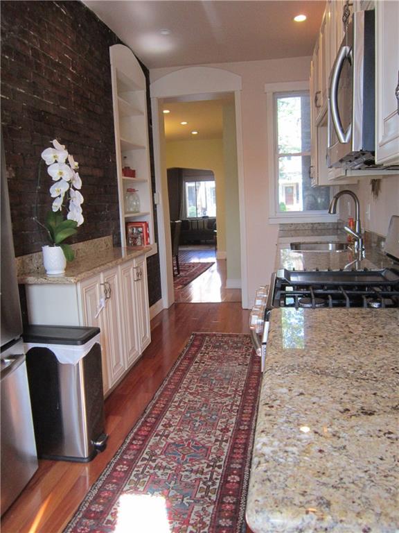 214 South Mathilda Street Friendship Park, PA 15224 - Photo 9 of 25 Updated kitchen with granite countertops, stainless steel appliances, built in shelf and exposed brick.