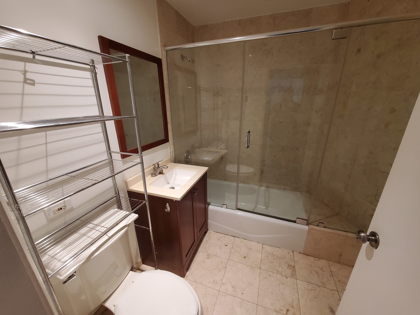 665 West Roscoe Street, Unit 1 Chicago, IL 60657 - Photo 7 of 10 a bathroom with a sink a toilet and shower