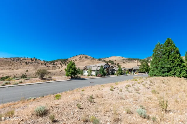 a view of a road with a house in the background