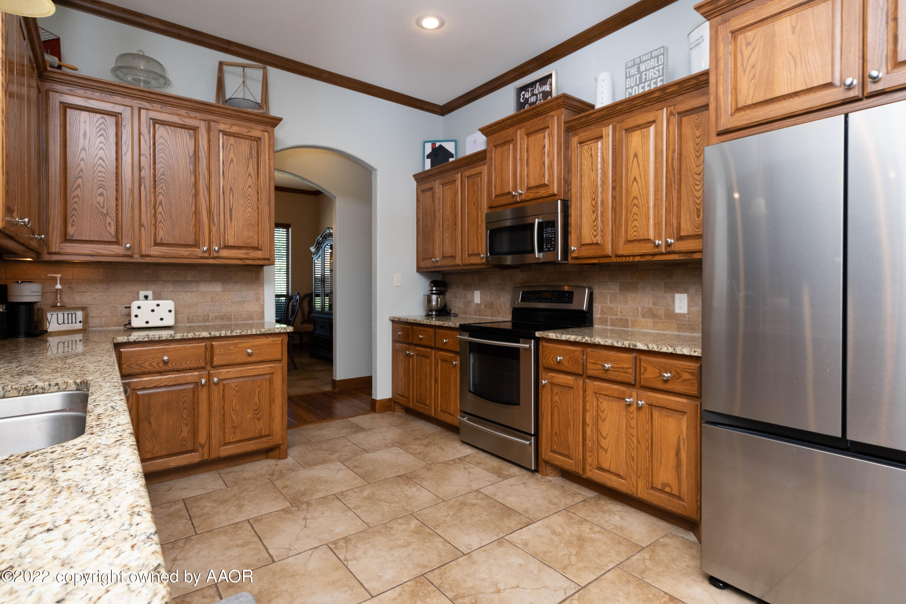 8417 Hamilton Drive Amarillo, TX 79119 - Photo 14 of 42 a kitchen with granite countertop a refrigerator stove top oven and sink