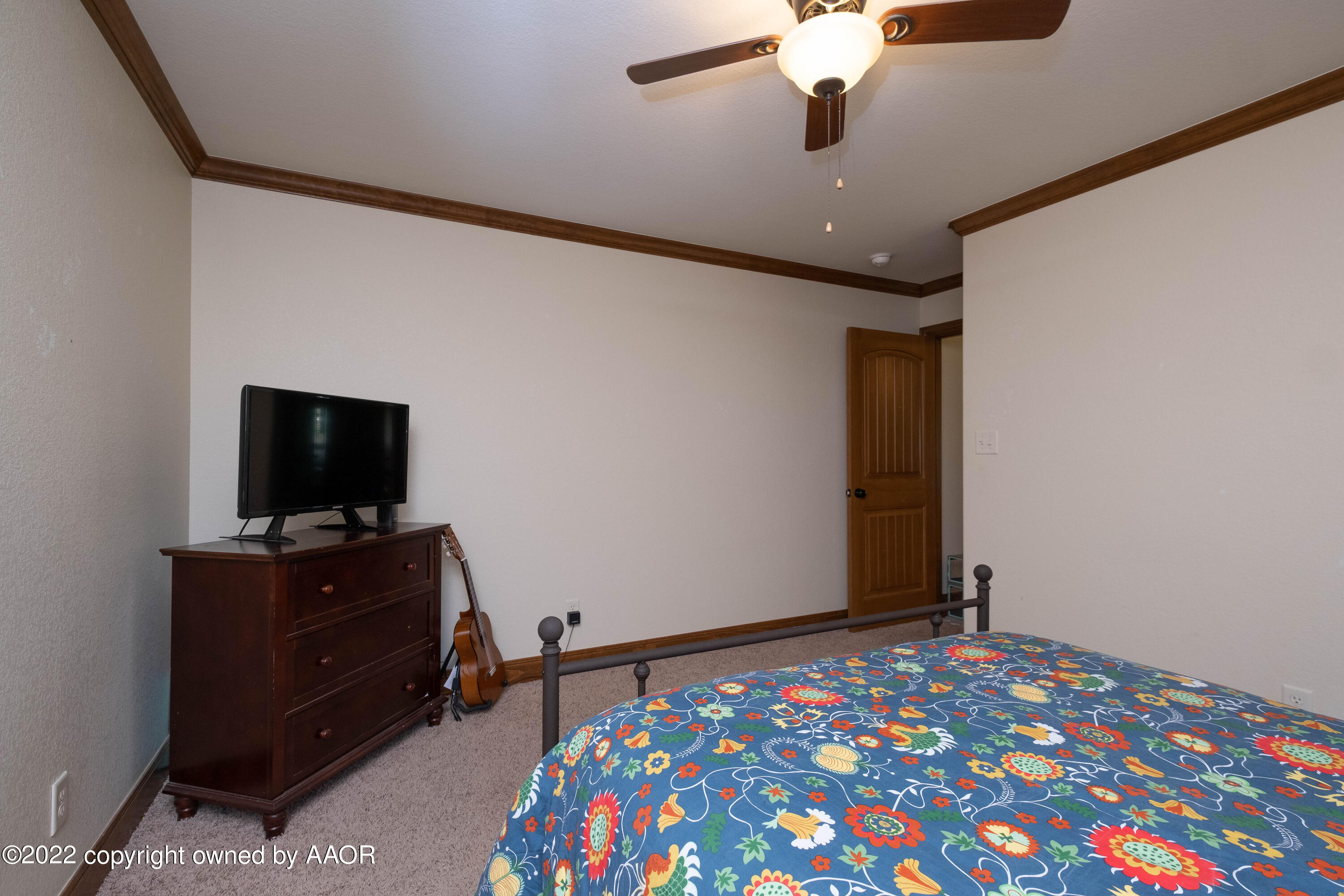8417 Hamilton Drive Amarillo, TX 79119 - Photo 21 of 42 a bedroom with a bed and a flat screen tv