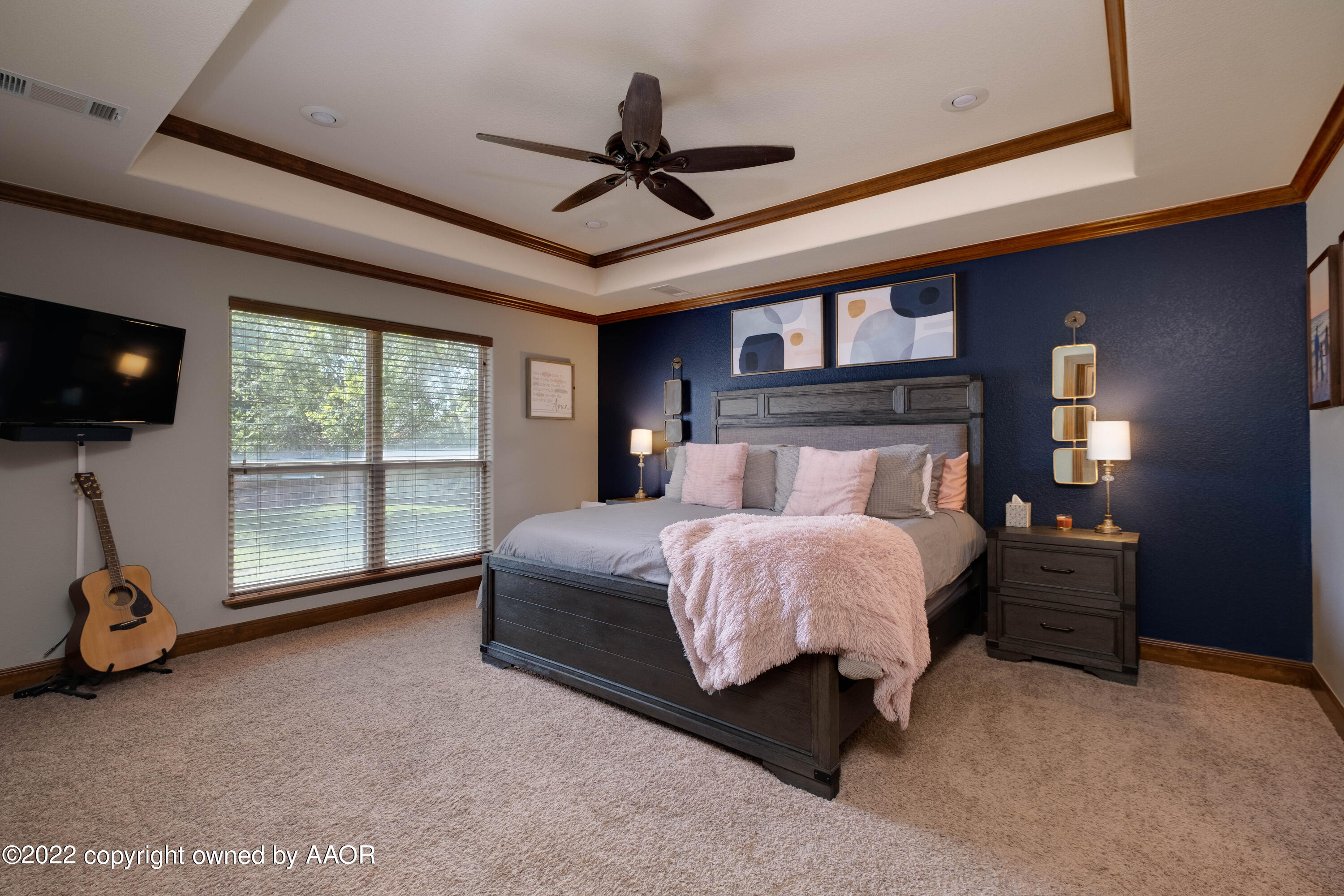 8417 Hamilton Drive Amarillo, TX 79119 - Photo 22 of 42 a bedroom with a bed tv and a large window