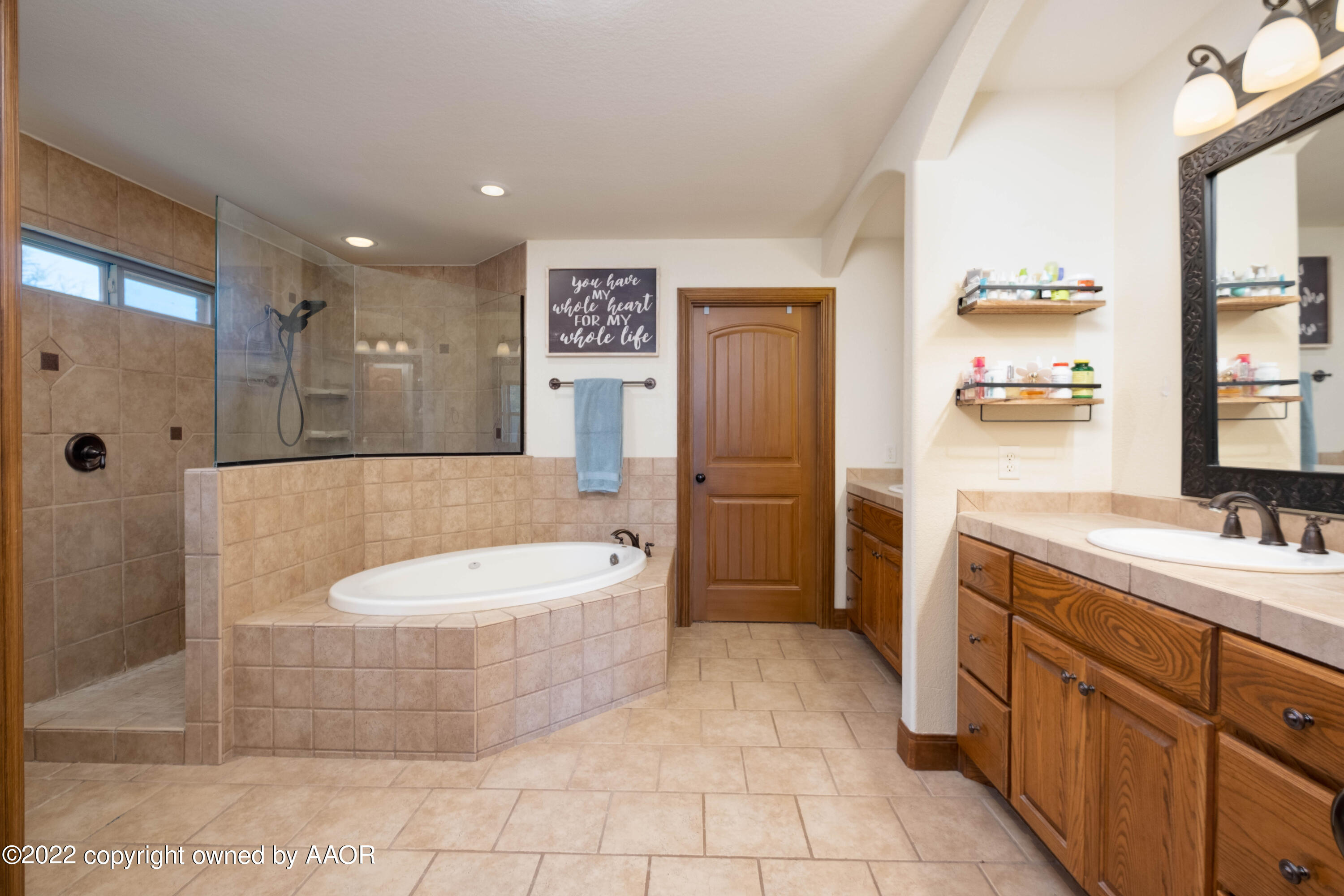 8417 Hamilton Drive Amarillo, TX 79119 - Photo 24 of 42 a spacious bathroom with a double vanity sink toilet mirror and bathtub