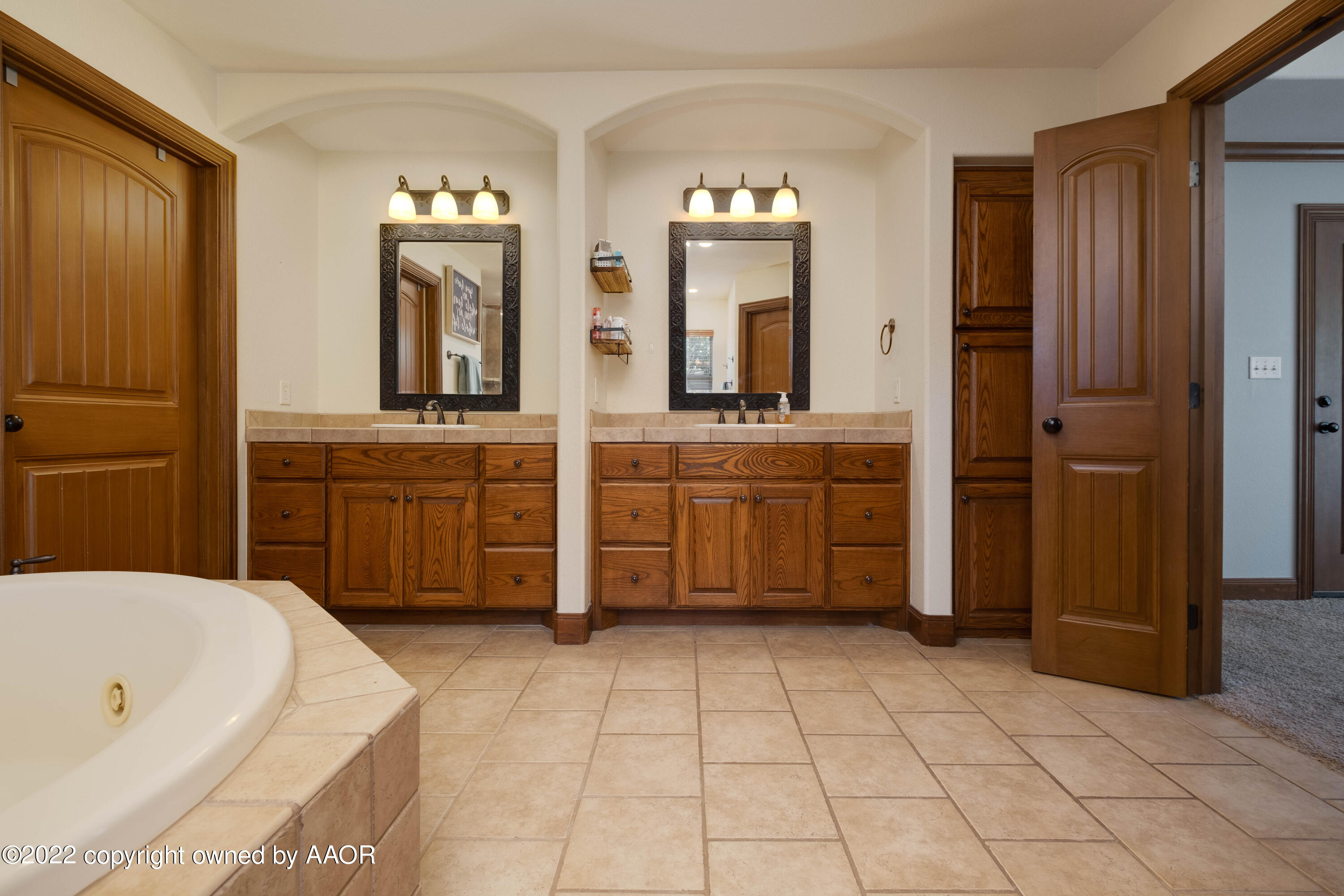 8417 Hamilton Drive Amarillo, TX 79119 - Photo 26 of 42 a bathroom with a tub sink and mirror