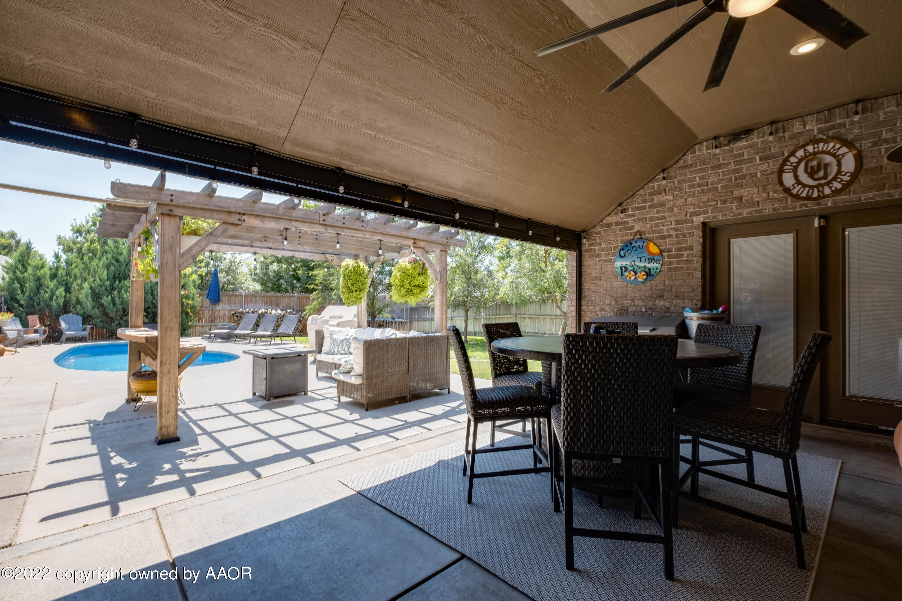 8417 Hamilton Drive Amarillo, TX 79119 - Photo 35 of 42 a view of a patio with a dining table and chairs next to a yard