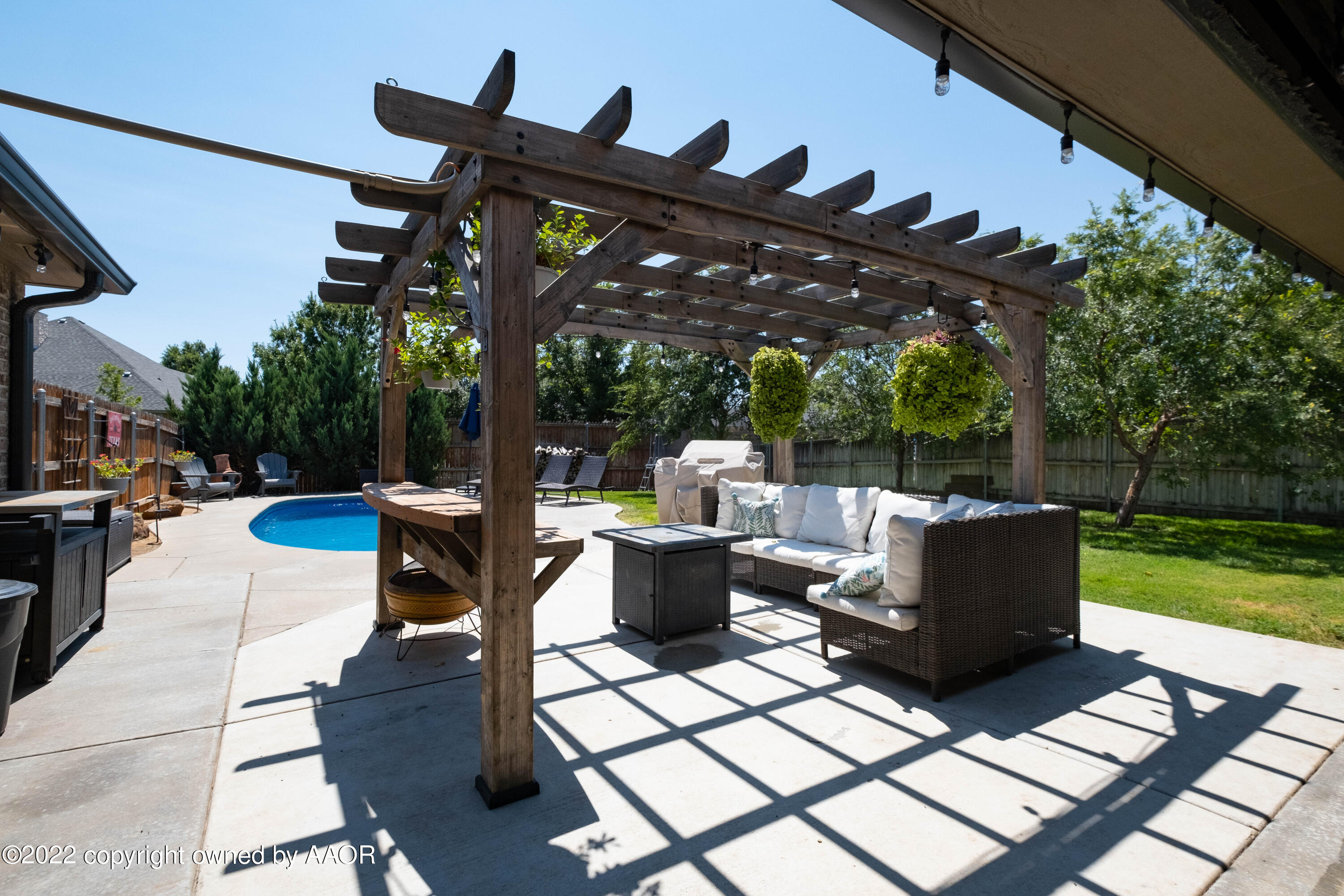 8417 Hamilton Drive Amarillo, TX 79119 - Photo 36 of 42 a view of a patio with table and chairs potted plants with wooden floor