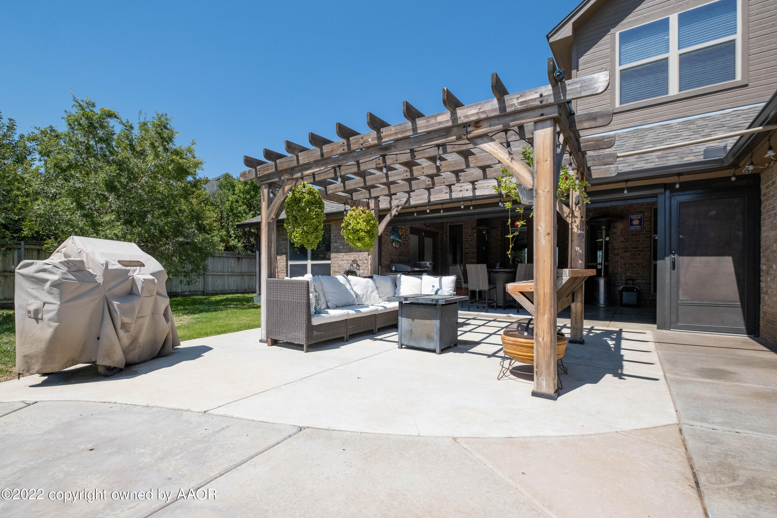 8417 Hamilton Drive Amarillo, TX 79119 - Photo 39 of 42 a view of a patio with a table and chairs and potted plants