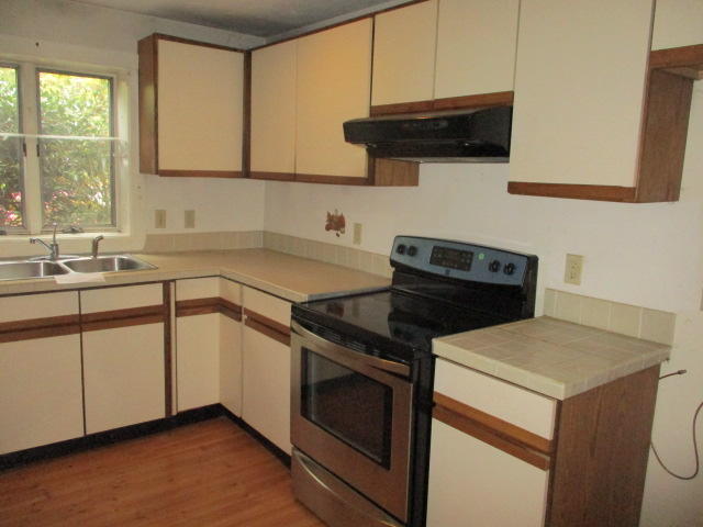 4 Shellback Way, Unit A Mashpee, MA 02649 - Photo 4 of 16 a kitchen with a sink stove and microwave