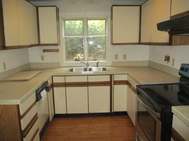 4 Shellback Way, Unit A Mashpee, MA 02649 - Photo 5 of 16 a kitchen with stainless steel appliances a sink and a stove