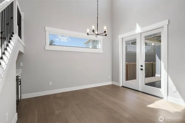 an empty room with windows and entryway