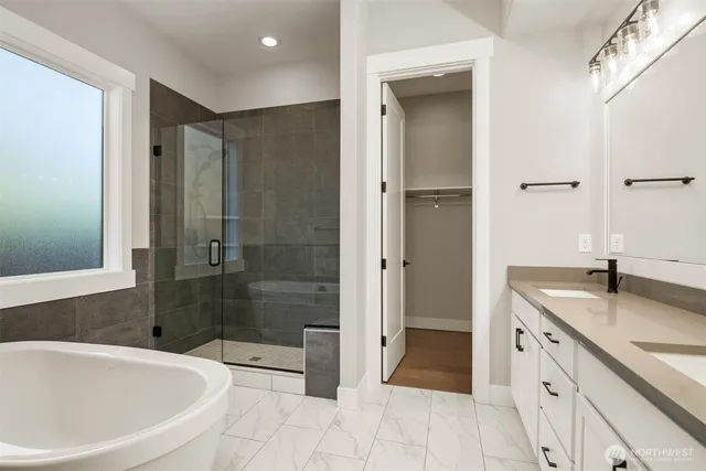 a bathroom with a granite countertop sink a toilet and shower
