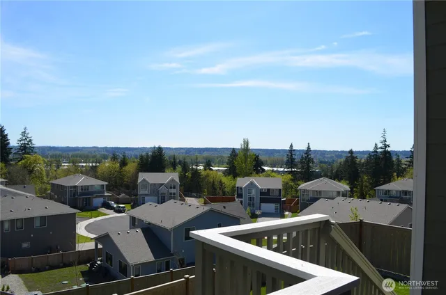 a view of roof deck with seating area and city view