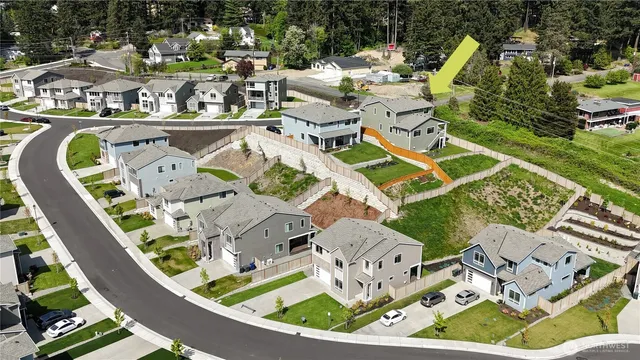 an aerial view of a house with a swimming pool patio and outdoor seating
