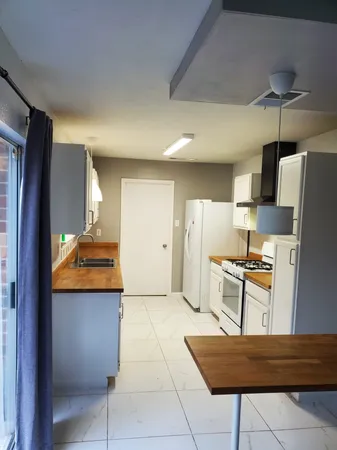 a kitchen with stainless steel appliances granite countertop a refrigerator and a stove