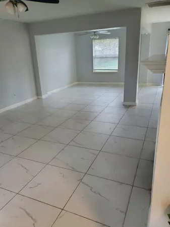 a view of an empty room and staircase