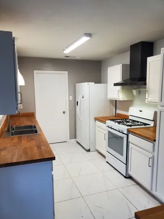 a kitchen with stainless steel appliances granite countertop a stove a refrigerator and a microwave