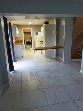 a view of a hallway with entryway and kitchen view