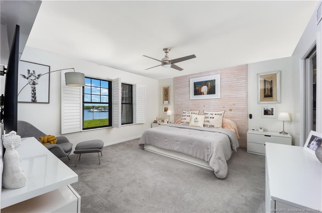 3100 Southeast Pruitt Road, Unit E204 Port St. Lucie, FL 34952 - Photo 11 of 40 a spacious bedroom with a bed couch and a window