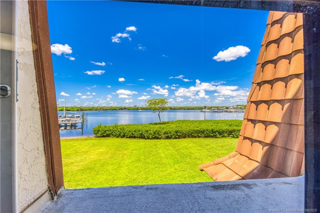 3100 Southeast Pruitt Road, Unit E204 Port St. Lucie, FL 34952 - Photo 12 of 40 a view of a swimming pool with an outdoor space and seating area
