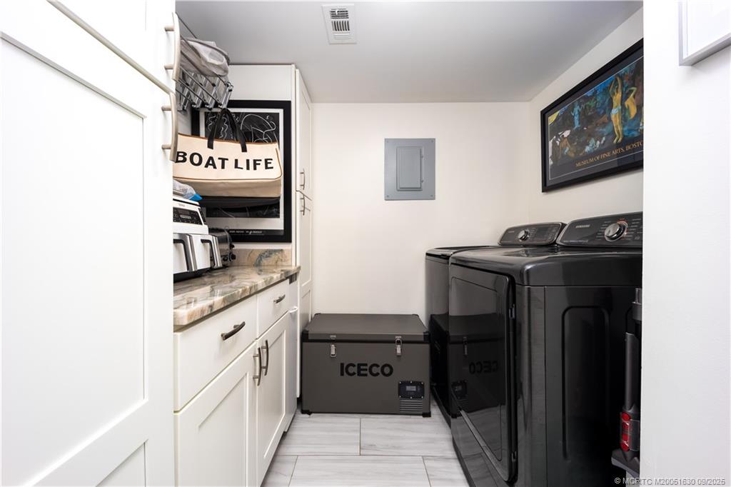 3100 Southeast Pruitt Road, Unit E204 Port St. Lucie, FL 34952 - Photo 19 of 40 a kitchen with stainless steel appliances granite countertop a refrigerator and a stove
